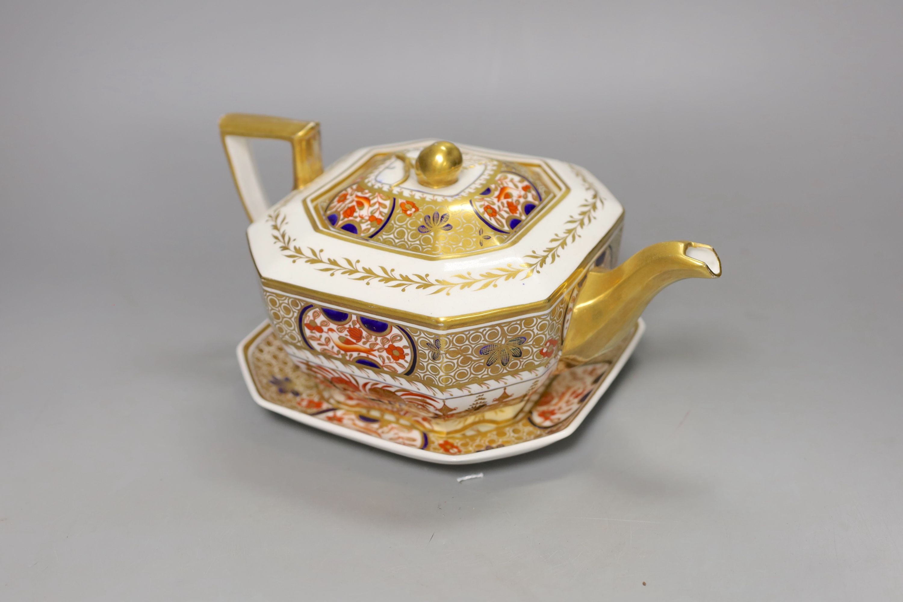 A Spode teapot cover and stand painted with Imari pattern, 1495, c.1820, 24.5 cm long